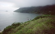 Photo of coast and hills on Ilha Grande, Brazil, historic home of pirates, prisoners and slaves, 2002. LINK to photo portfolio