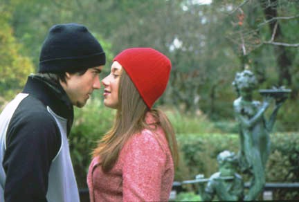 Photo of woman and man looking closely at each other.
